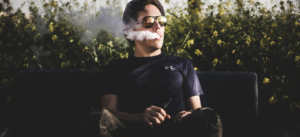 Man sitting on park bench smoking