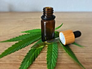 cbd oil bottle on hemp leaf